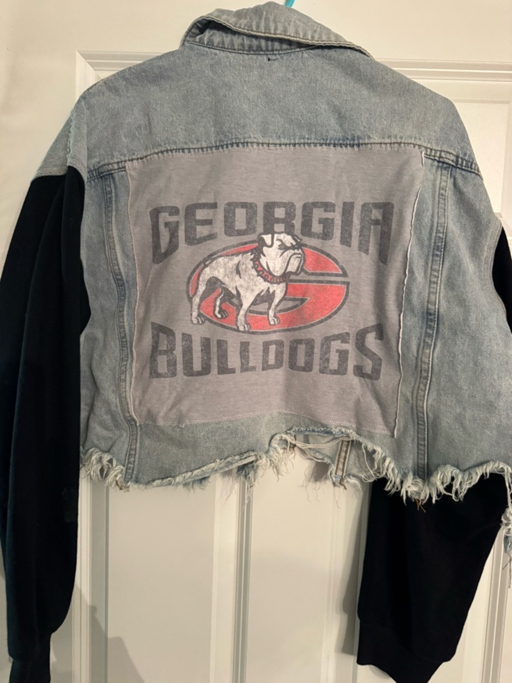 GEORGIA Unbranded Light Blue Distressed Cropped Denim Jacket with Black Sleeves